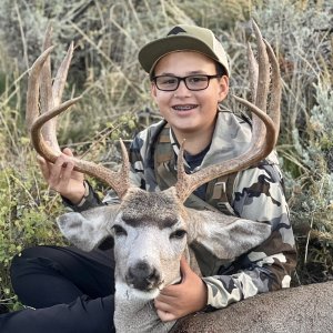 Happy Youngster with His Buck